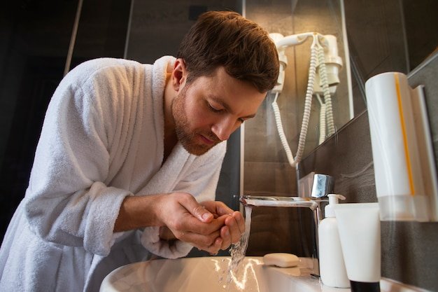 man wearing bathrobe using hard water in dubai